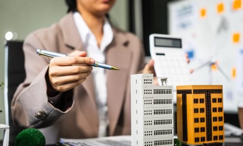 A young businesswoman is working at her desk, managing legal matters related to real estate