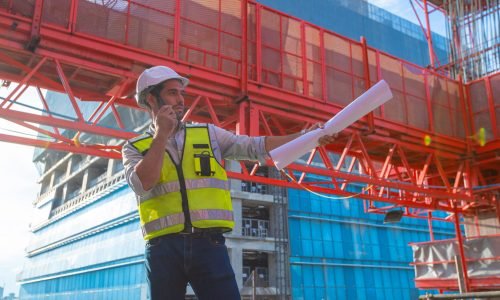 Portrait of an engineer designing a large project inspecting the job site to meet specifications.